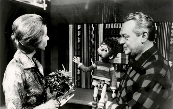 Svarthvitt bilde av TV-aksjonen i 1978, med en kvinne og Rolf Kirkevaag med dukken Titten Tei